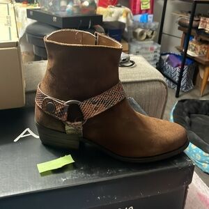 suede boots from ARTISAN BY ZIGI feature a sleek snakeskin pattern buckle.